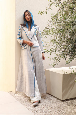 Shimmer-The Art of Layers S.LO1 - a luxurious grey check abaya adorned with intricately cut leather floral motifs, beautifully layered across the design and finished with refined blue piping.