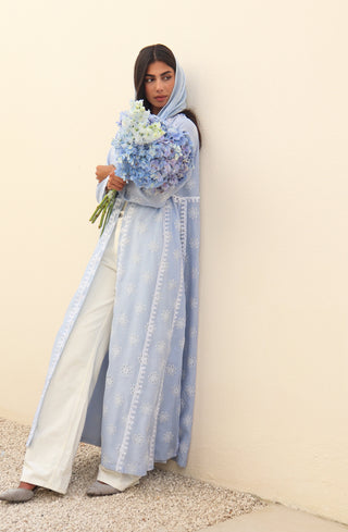 The Language Of Flowers S.FO1-an elegant powder blue abaya featuring delicate floral cutwork fabric and intricate white embroidery.