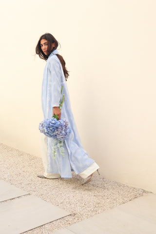 The Language Of Flowers S.FO1-an elegant powder blue abaya featuring delicate floral cutwork fabric and intricate white embroidery.