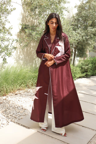 The Language Of Flowers S.FO5 -striking burgundy abaya adorned with delicate white floral details and elegant contrast piping.