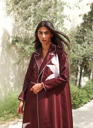 The Language Of Flowers S.FO5 -striking burgundy abaya adorned with delicate white floral details and elegant contrast piping.