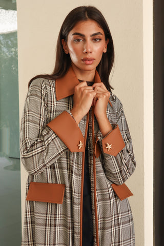Shimmer - The Art of Layers S.LO8 - a refined check abaya featuring a rich brown leather collar, cuffs, and pocket details for a sophisticated finish. 