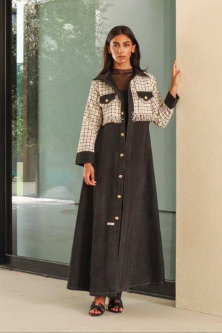 The Art of Layers S.LO10 - striking black abaya featuring elegant check tweed detailing, delicate fringe accents, and refined gold buttons. 