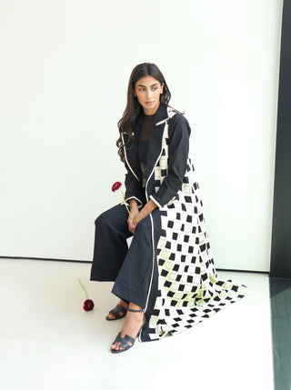 The Art of Layers S.LO9 - an elegant black abaya featuring delicate white lace panels and refined white piping for a striking contrast. 