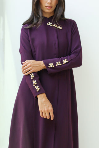 A captivating deep purple abaya, Letters From Kyoto S.KO2 features delicate gold floral details on the neckline and sleeves.